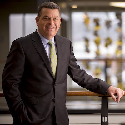 Man with yellow tie standing