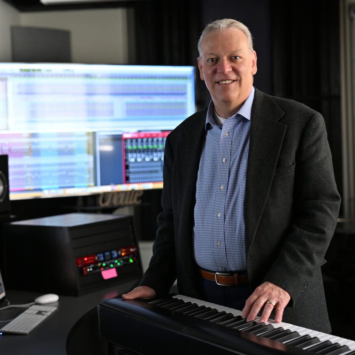 Dr. Don Reddick poses in music studio