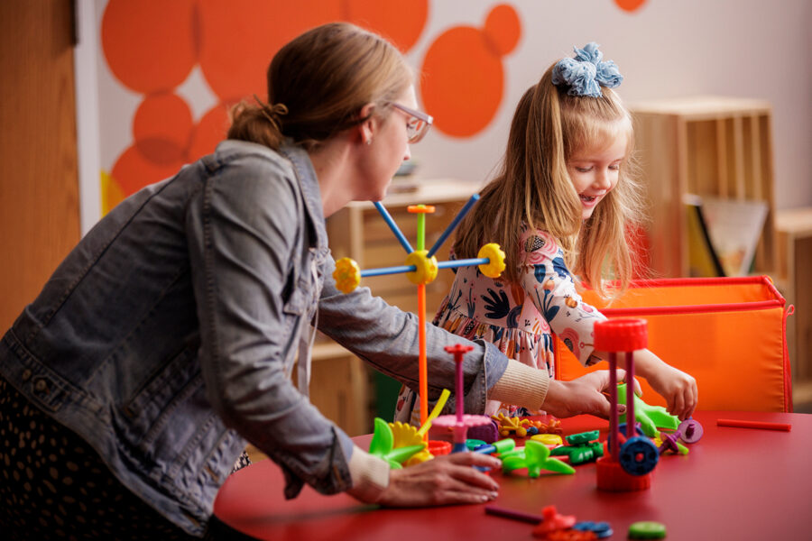 Image of woman playing with little girl