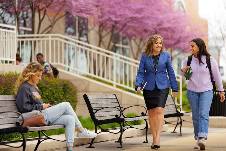 Business professor engages in conversation with student