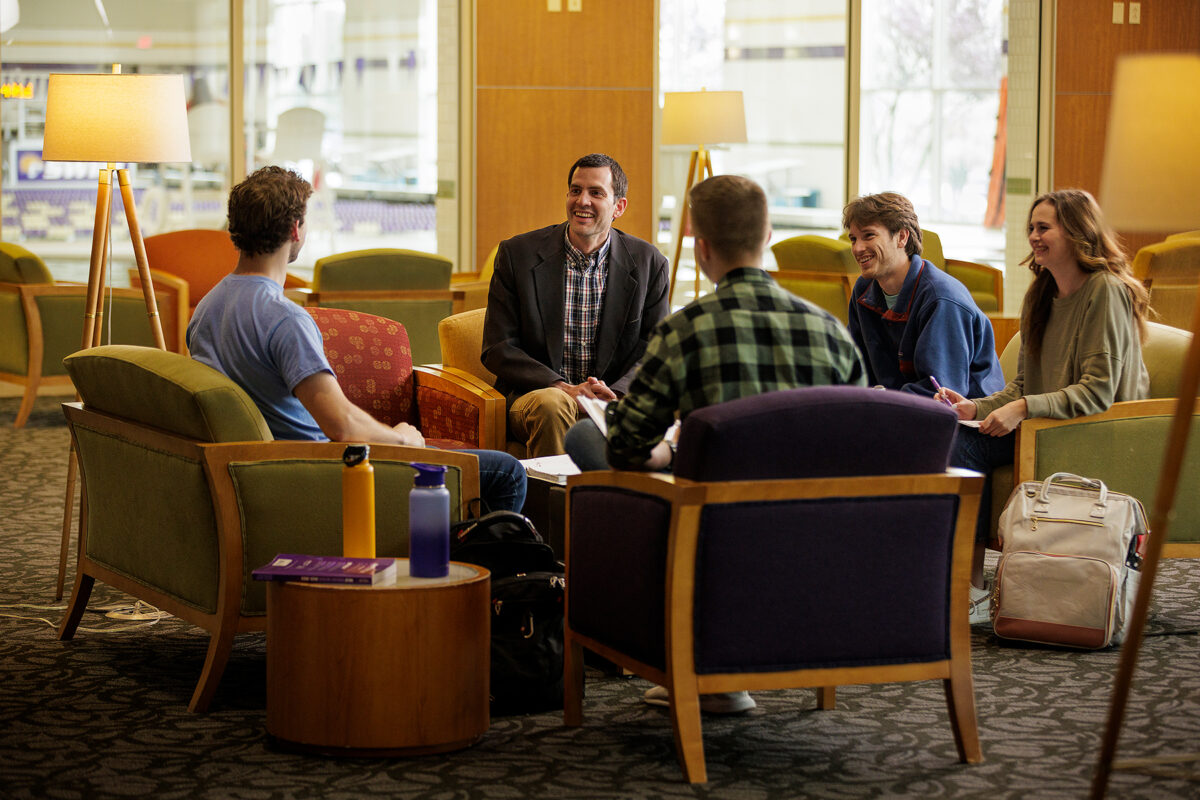 Dr. Ryan Himes and students talk in Perry Recreation Center lobby.