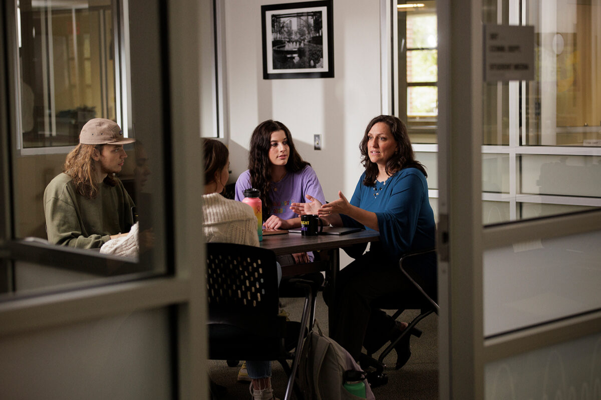 group of students meeting with professor