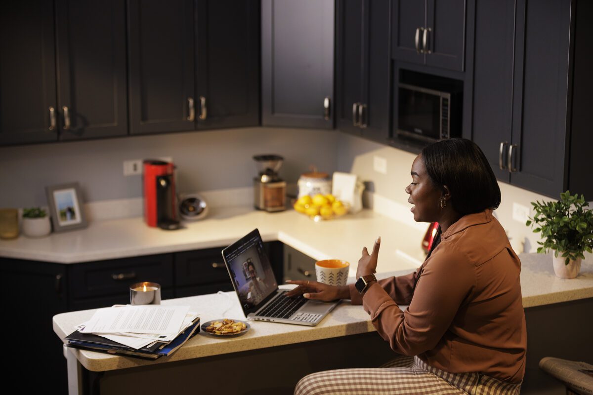 Woman on a laptop doing work in her kitchen