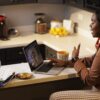 Woman on a laptop doing work in her kitchen