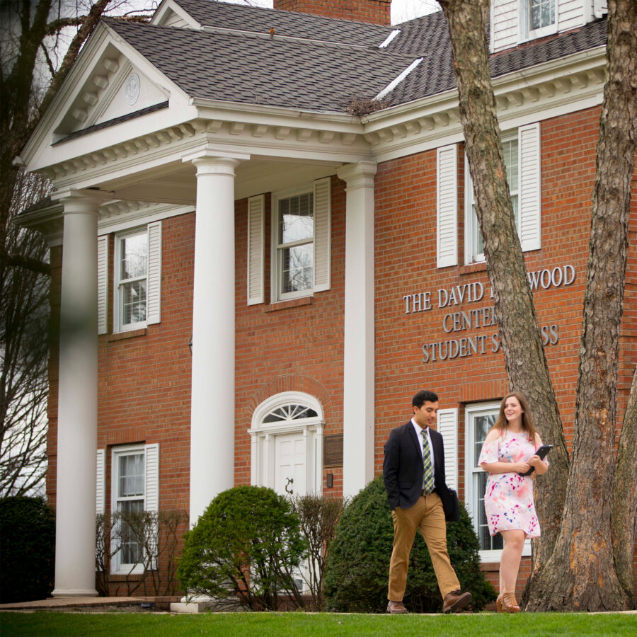 Two students walking in front of the Elwood Center