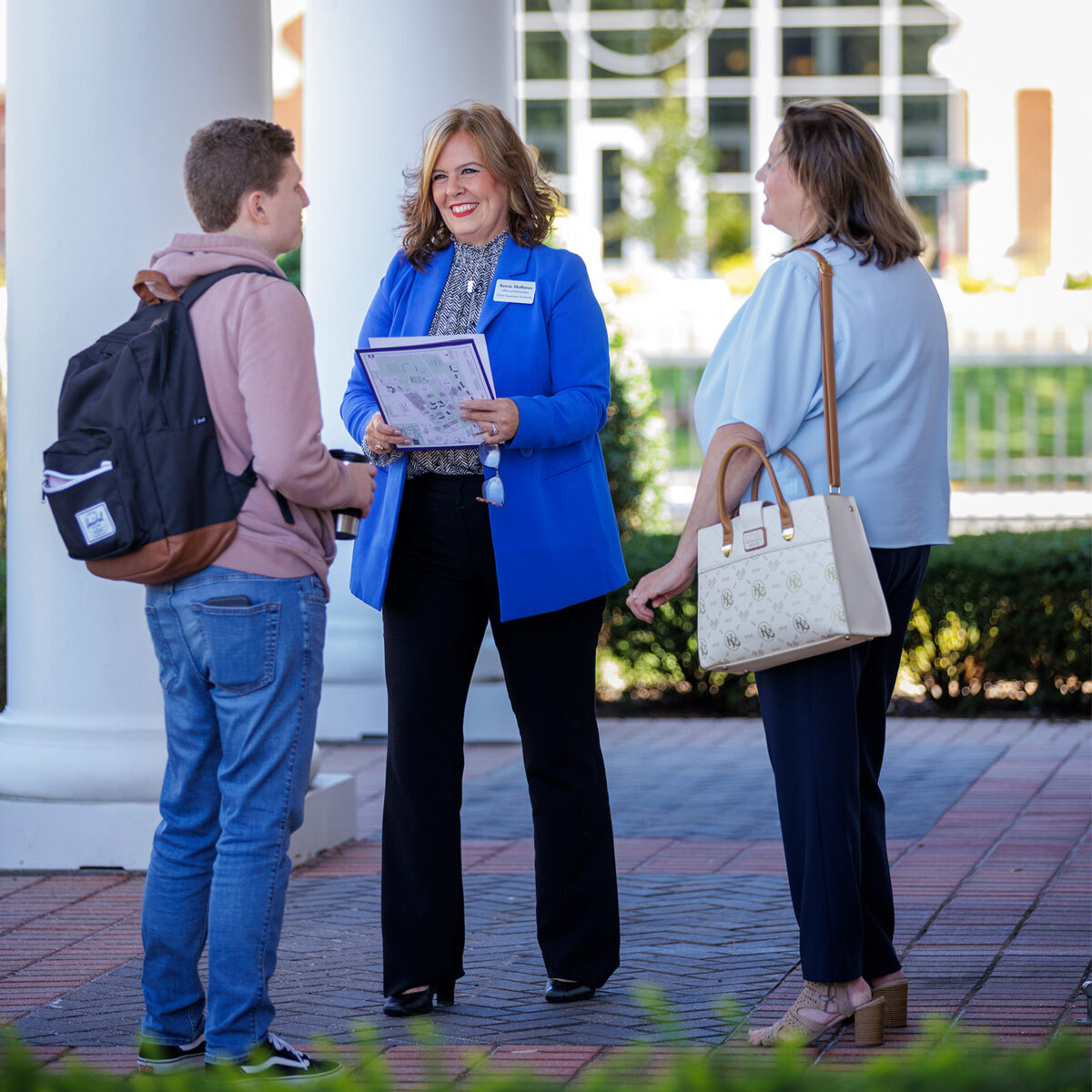 Admissions counselors with student