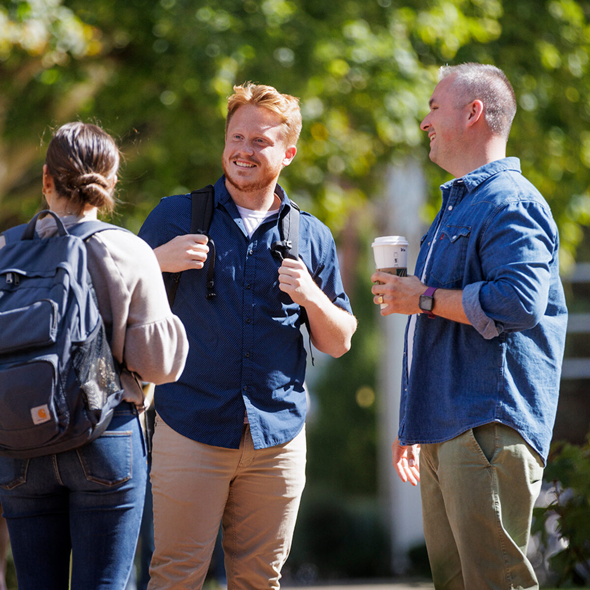 Photo of Drew Benson having a conversation with students