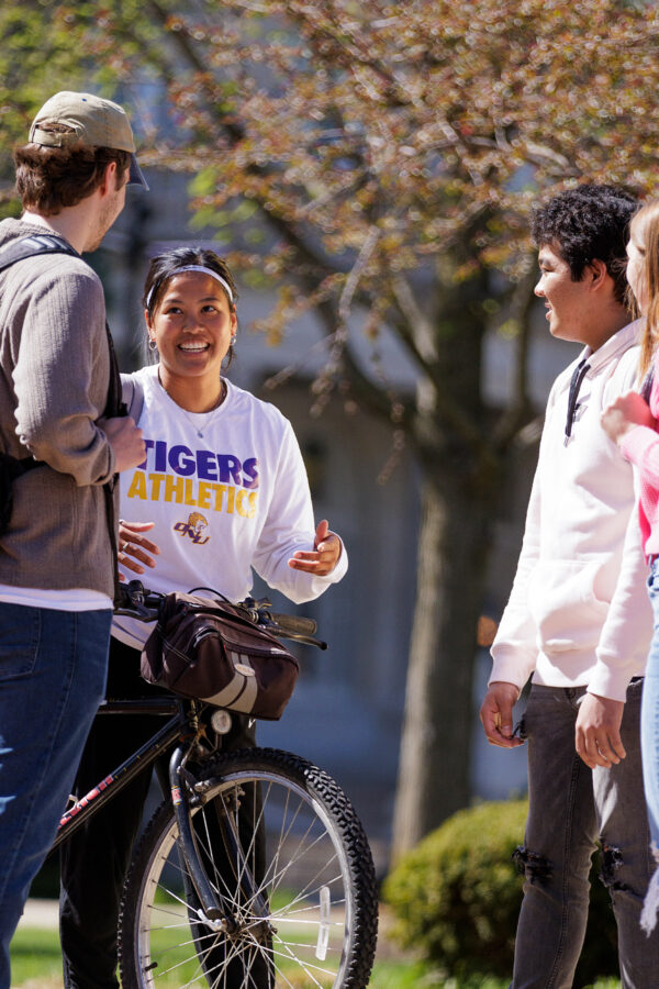 Students on main campus esplanade talking, laughing.