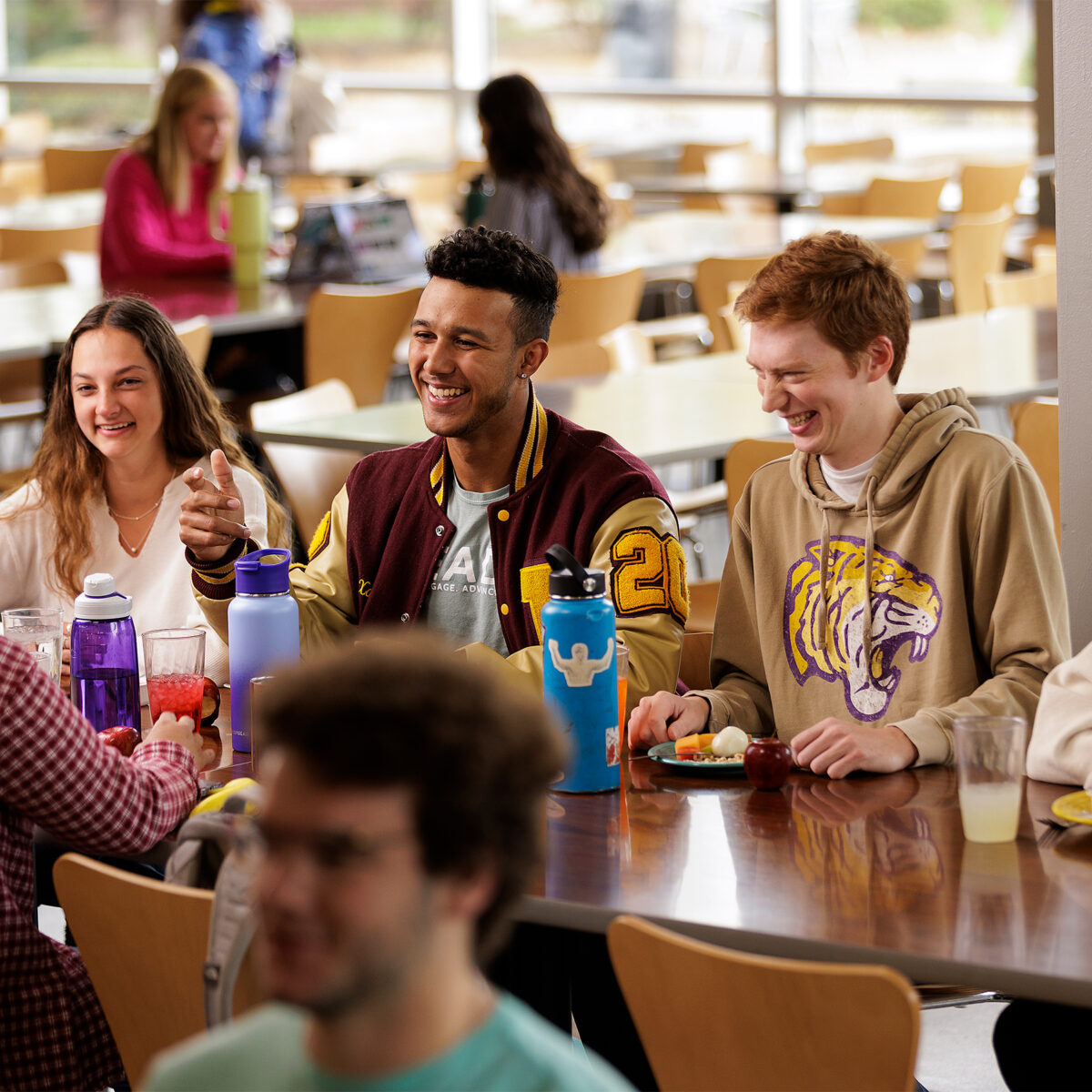 Group of students enjoying a meal together in the campus dining hall