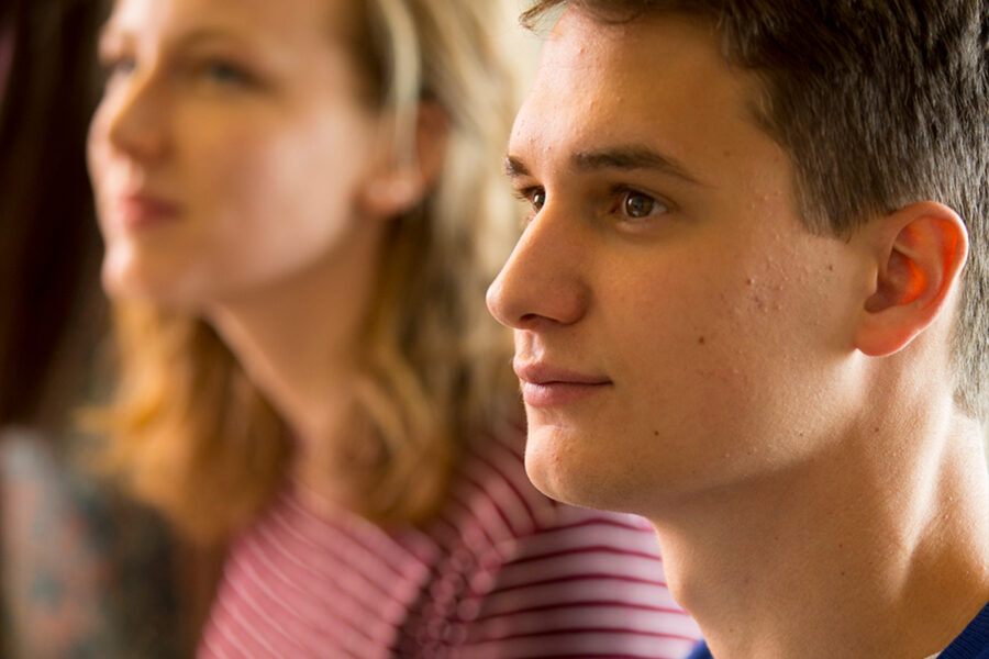 Two students paying attention in class