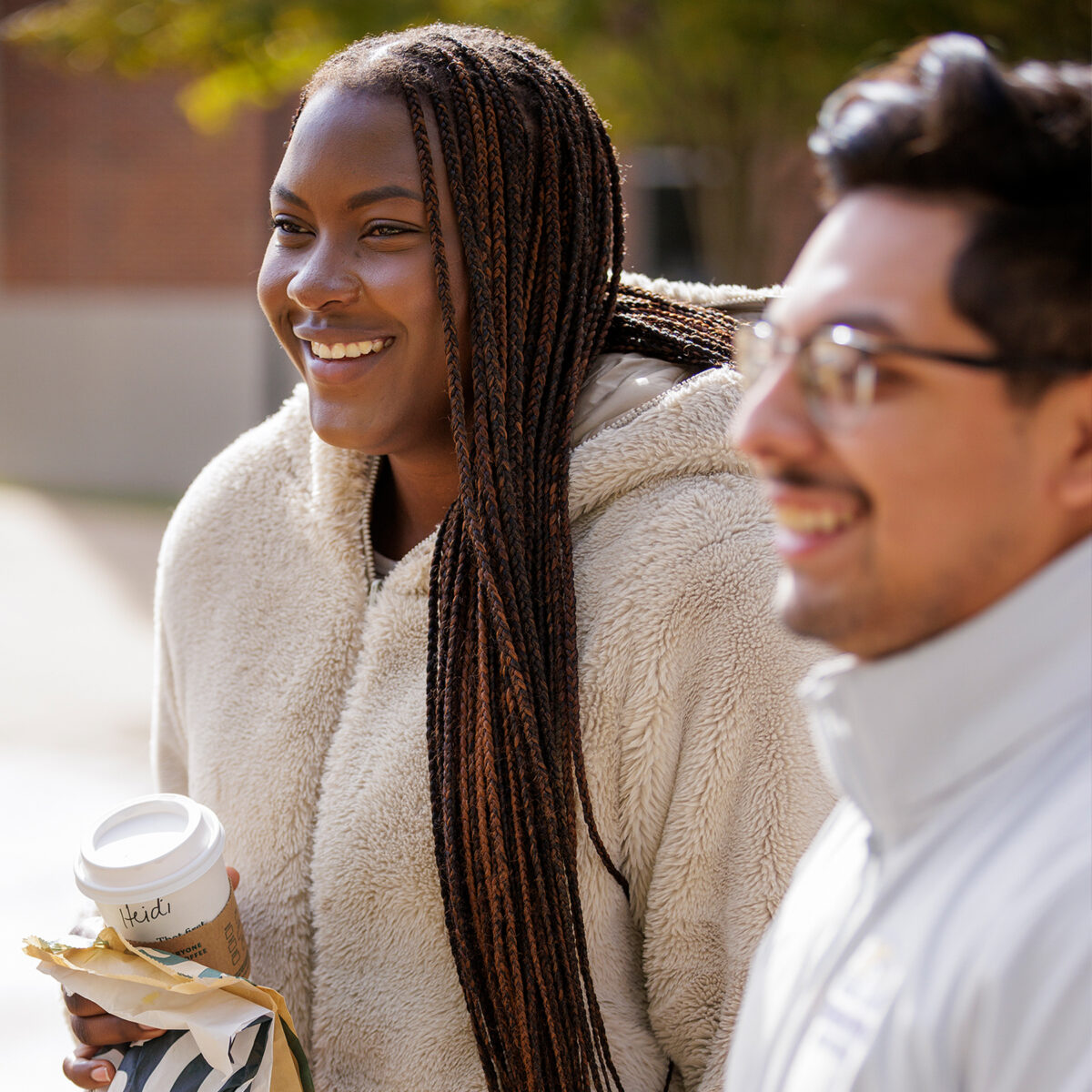 Close up shot of two students conversing at the quad