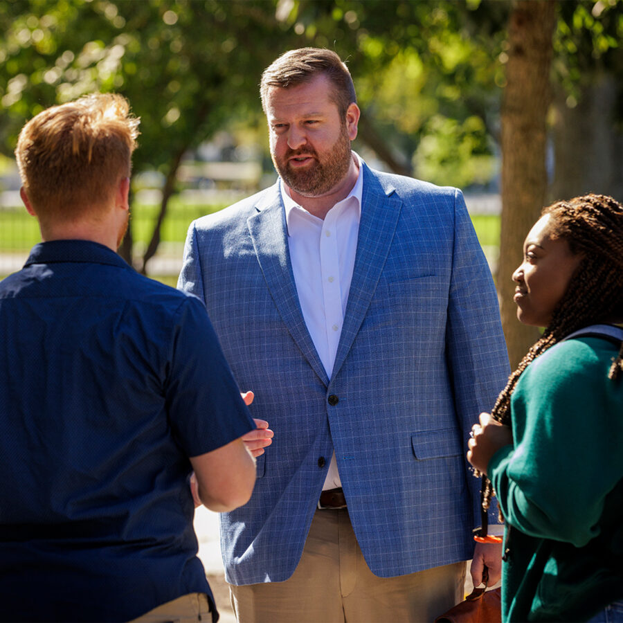 Dr. Stephens chatting with two students