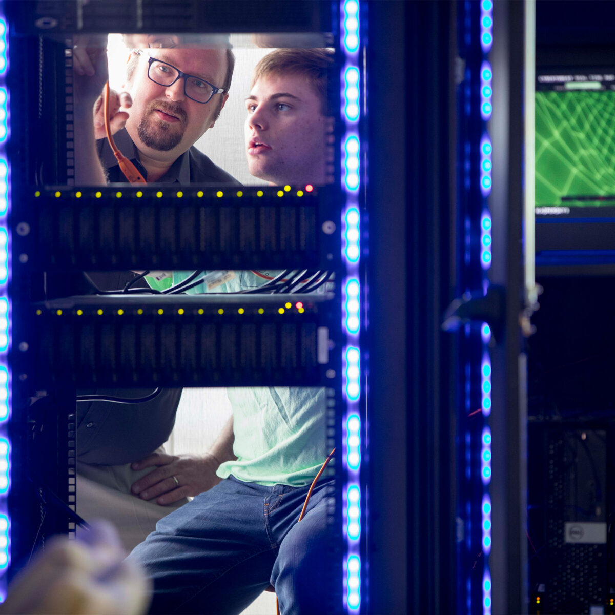 Two people examining stacks