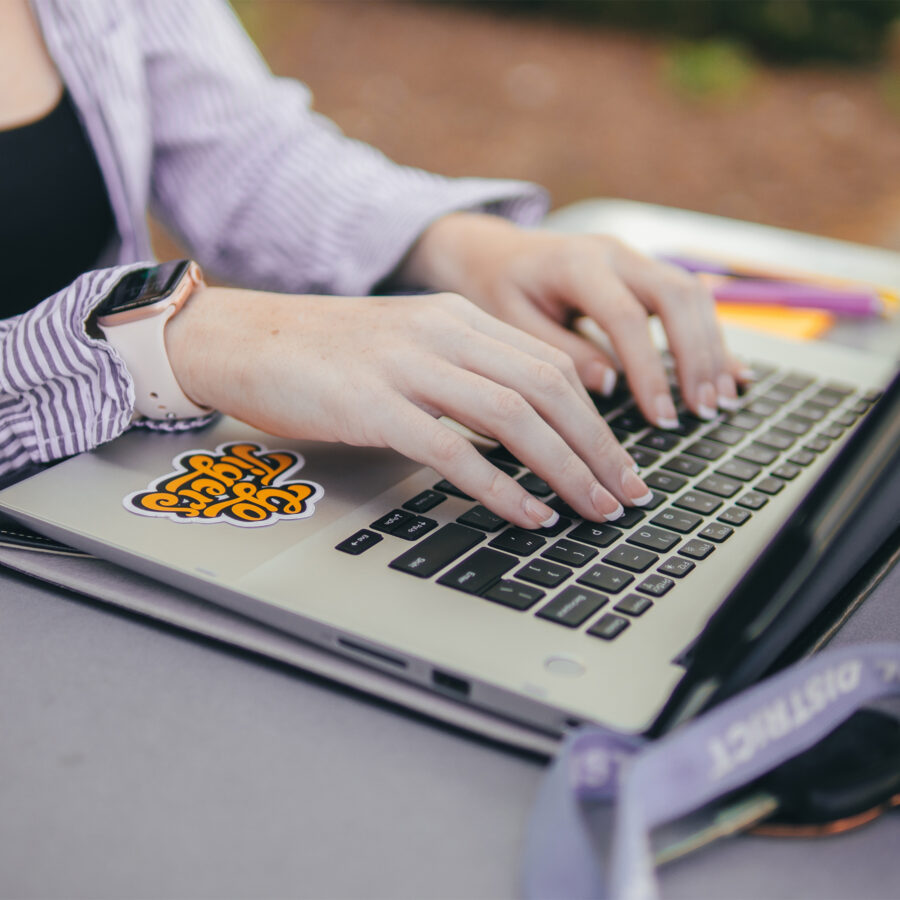 student hands on laptop