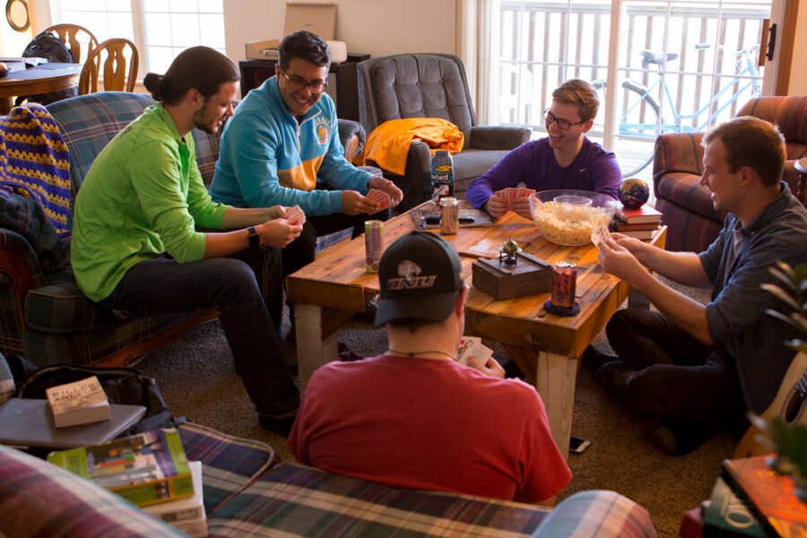 Students playing a game in their apartment