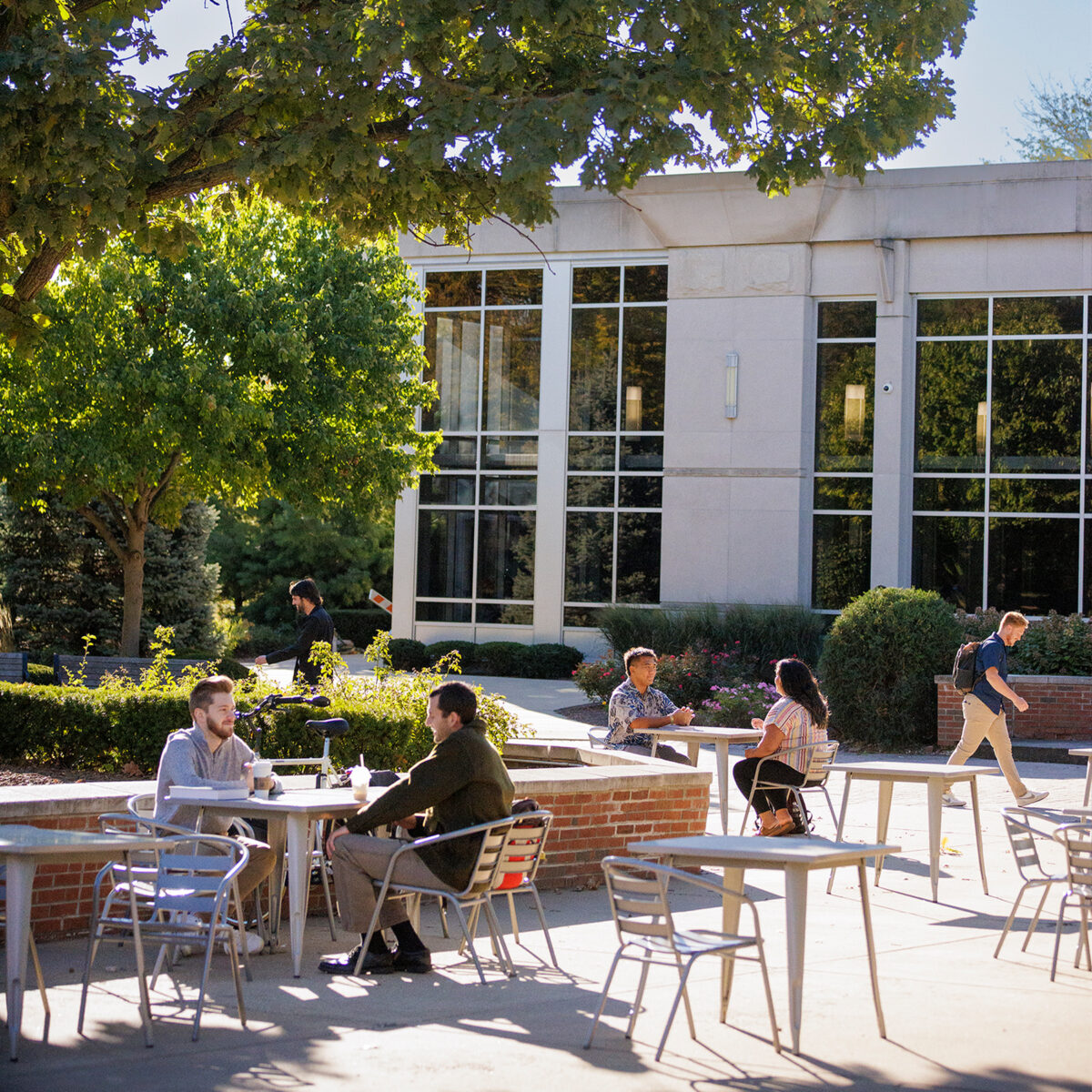 People sitting at tables in the quad