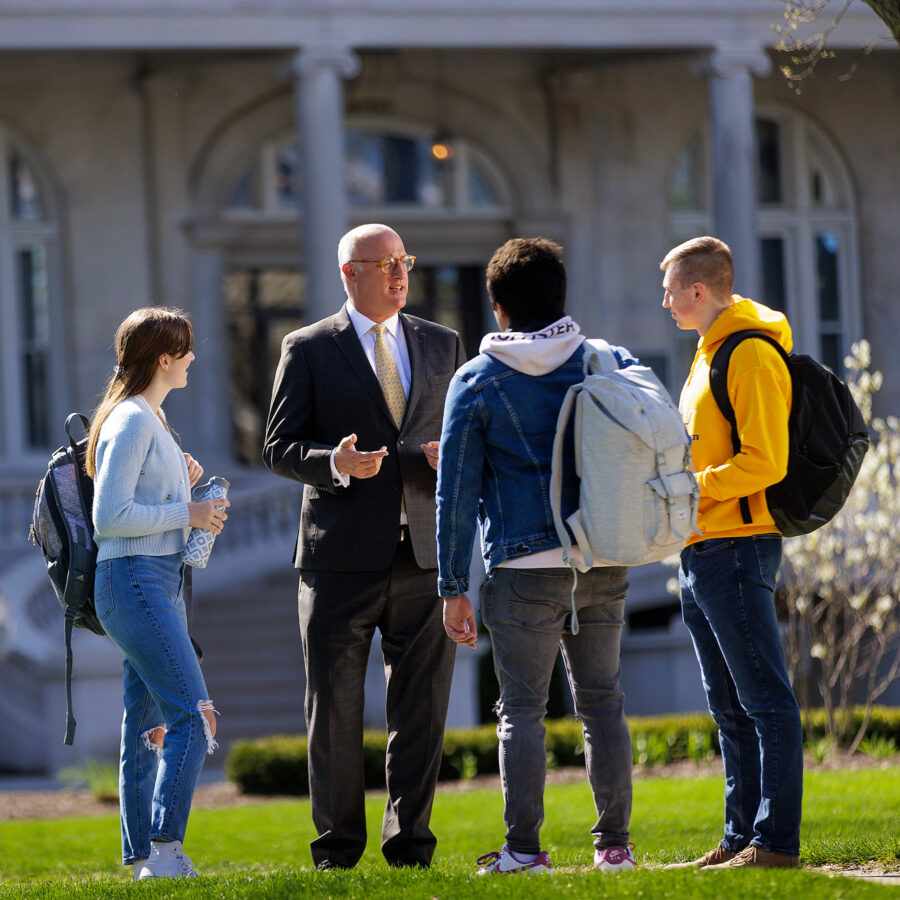 President Dr. Gregg Chenoweth meets with students in front of Burke Administration Bldg.