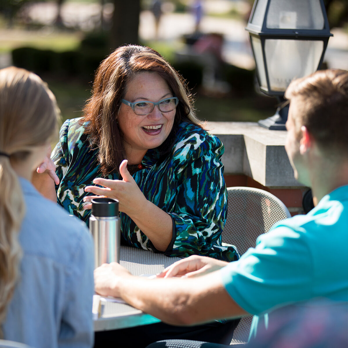 Photo of professor having a conversation with students