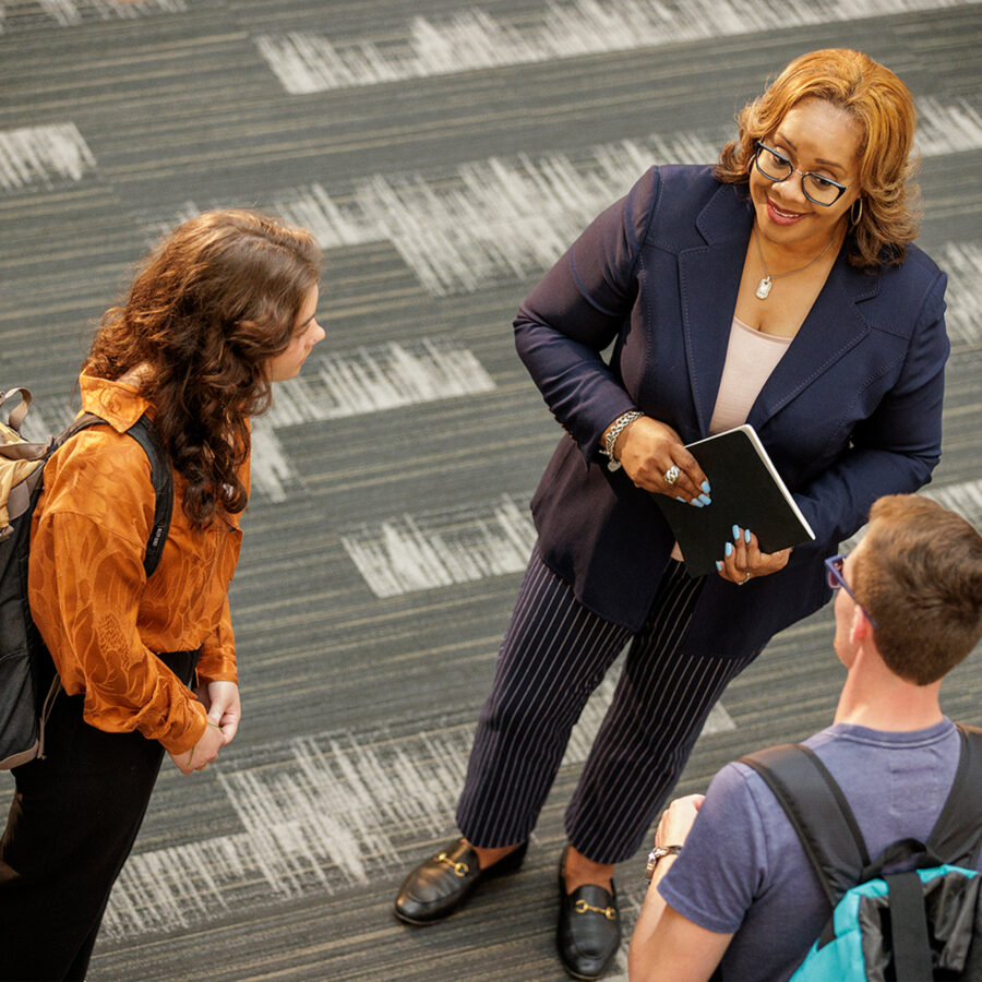 professor speaking with male and female student