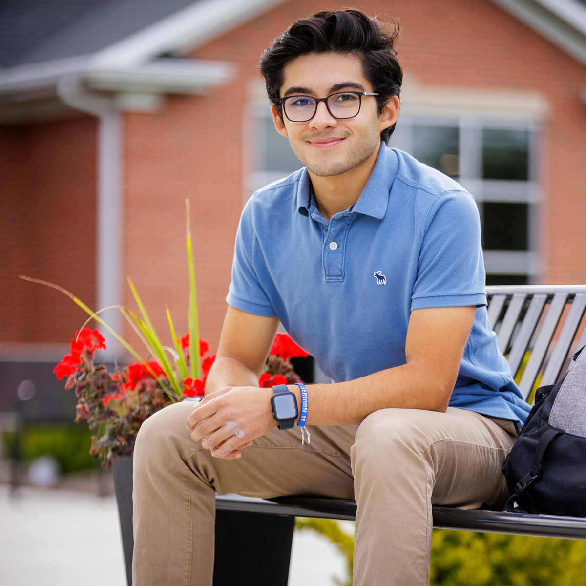 Smiling student sitting on a bench