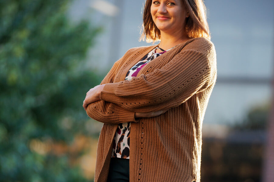 Portrait of woman wearing a sweater with her arms crossed