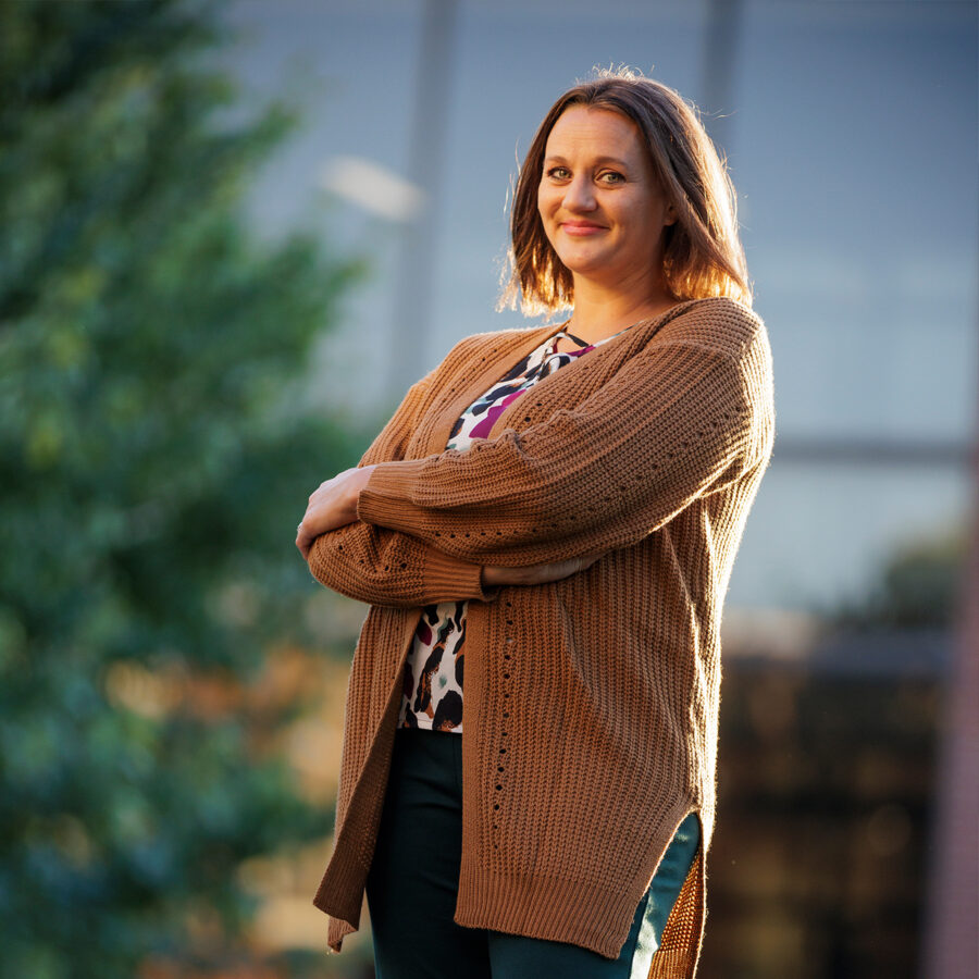 Portrait of woman wearing a sweater with her arms crossed