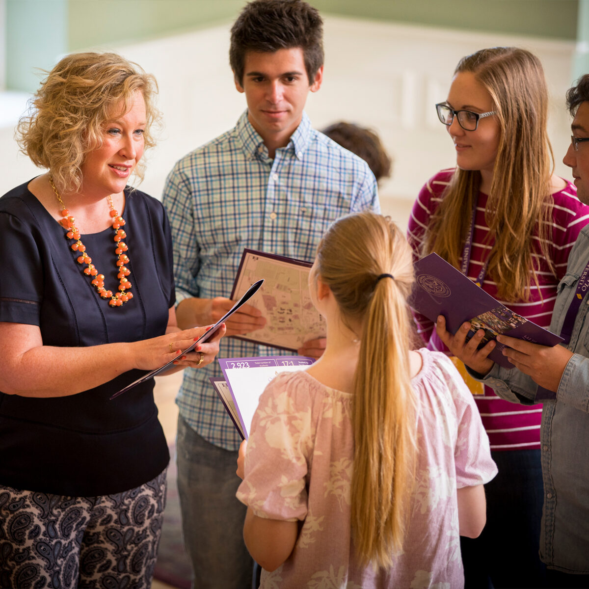 Admissions counselor having a conversation with students