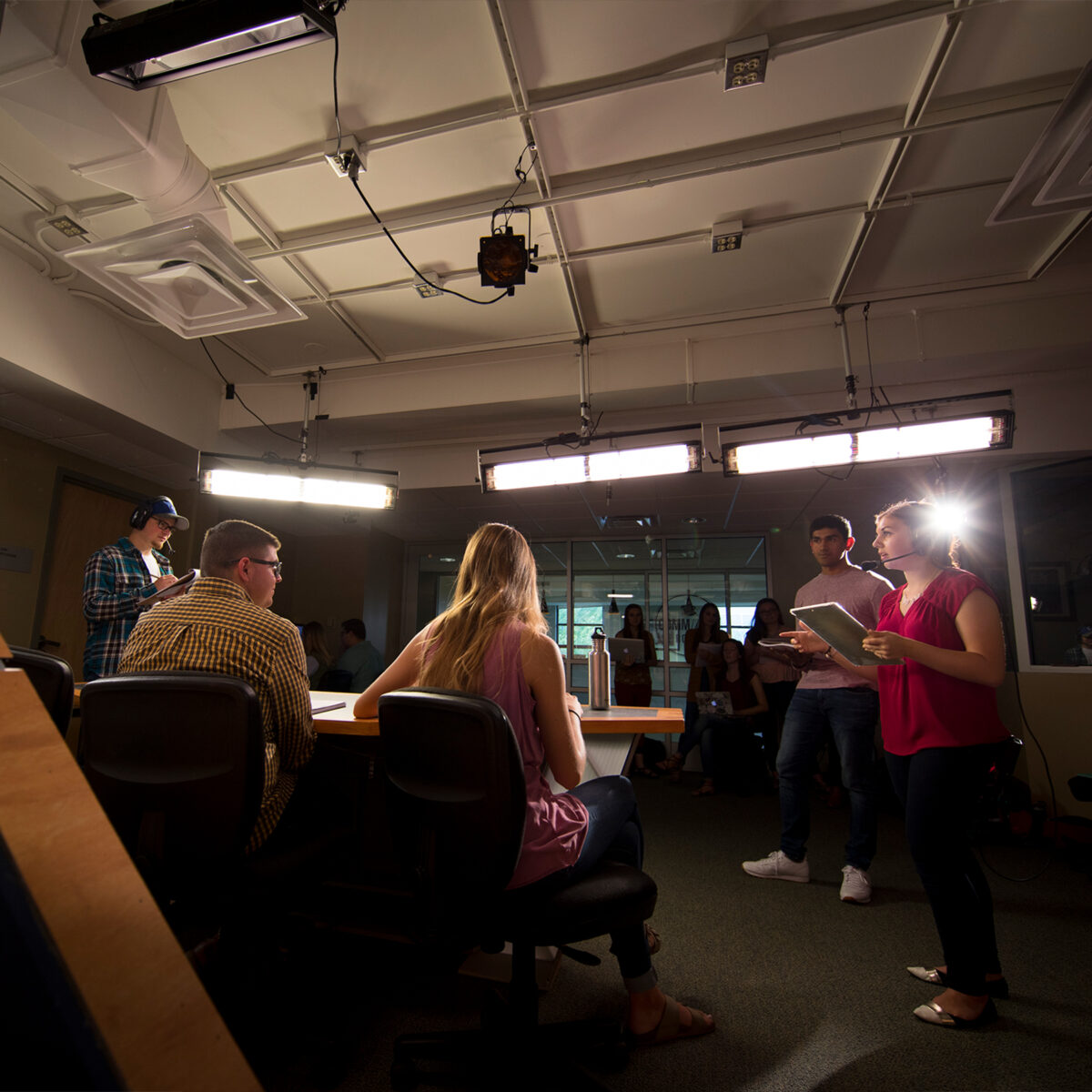 Students interact on set of the video studio
