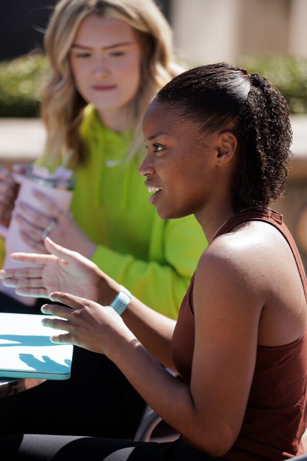 Two students sitting in the Quad