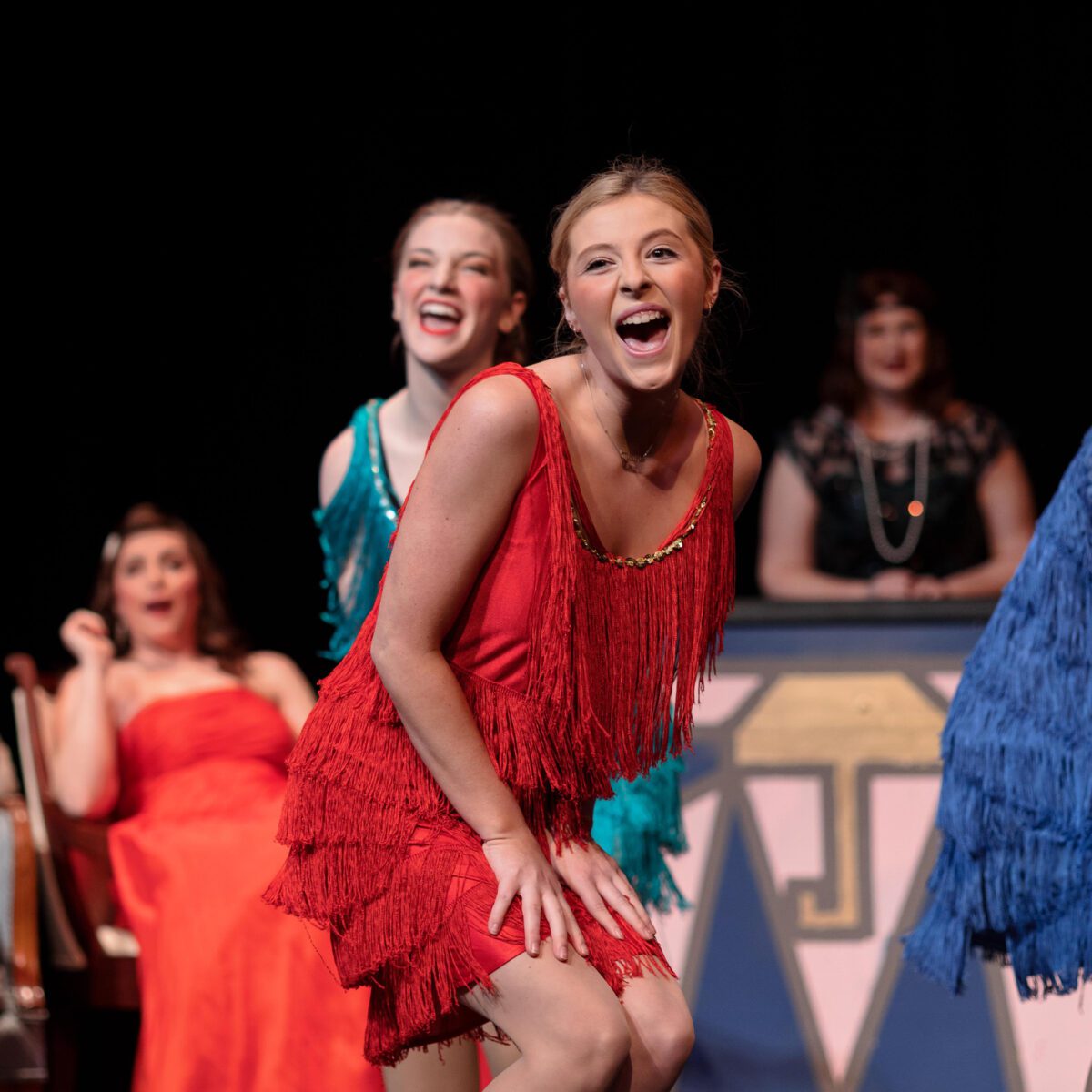 Female student on stage performing on set