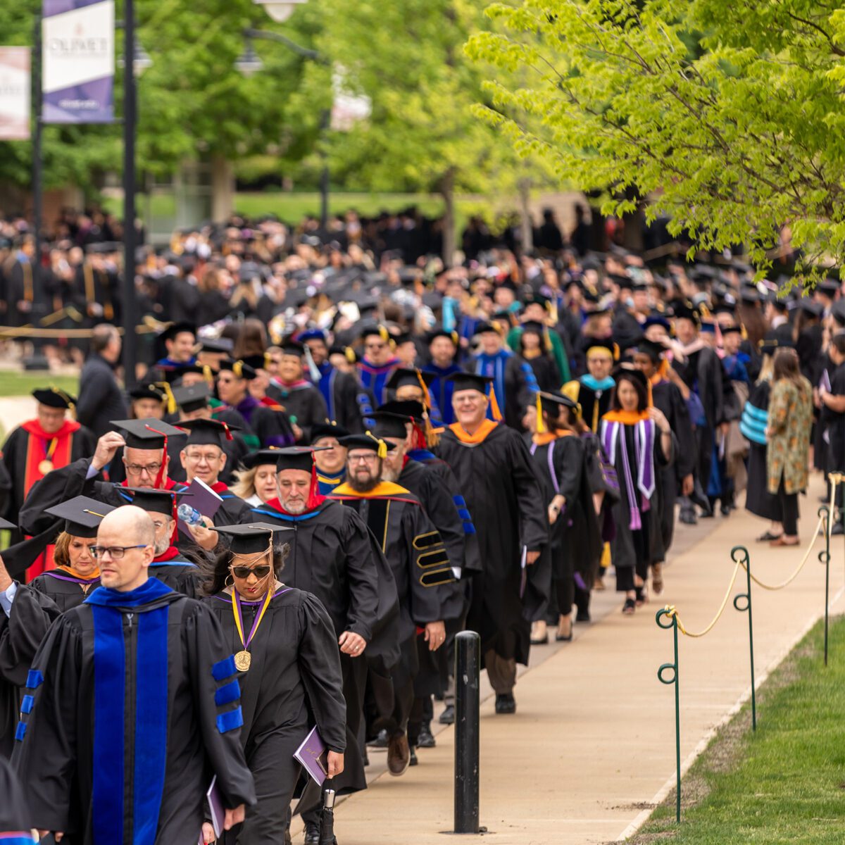 Graduates walking towards Centennial Chapel