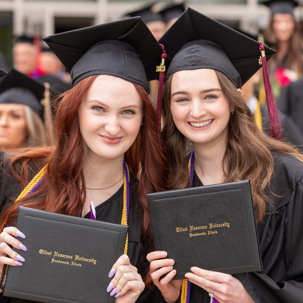 Two smiling graduates