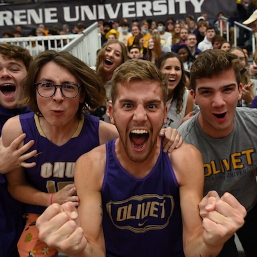 male students cheering at Homecoming basketball game