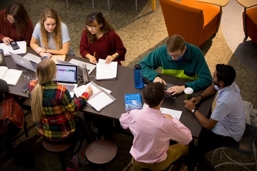 Group of students studying at a table in the library