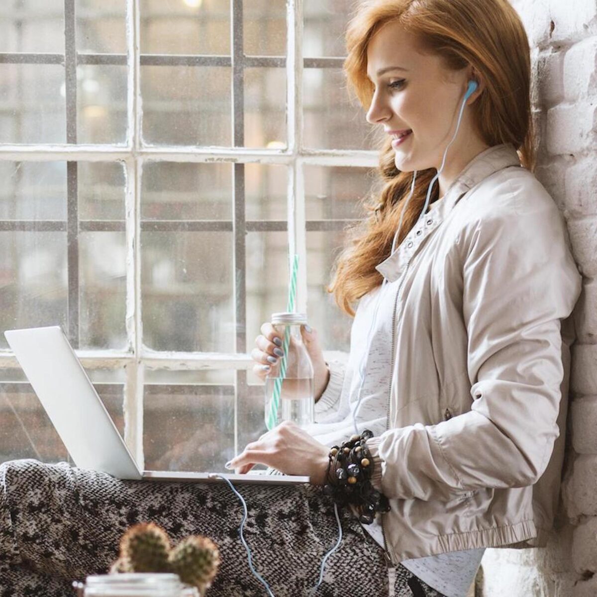 girl in window on laptop