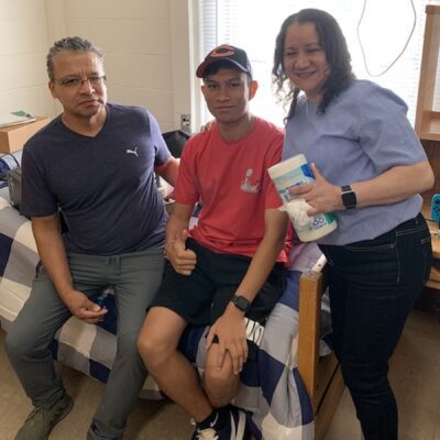 Hispanic family in male dorm room