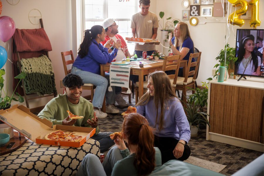 Group of friends hosting a pizza party in their apartment