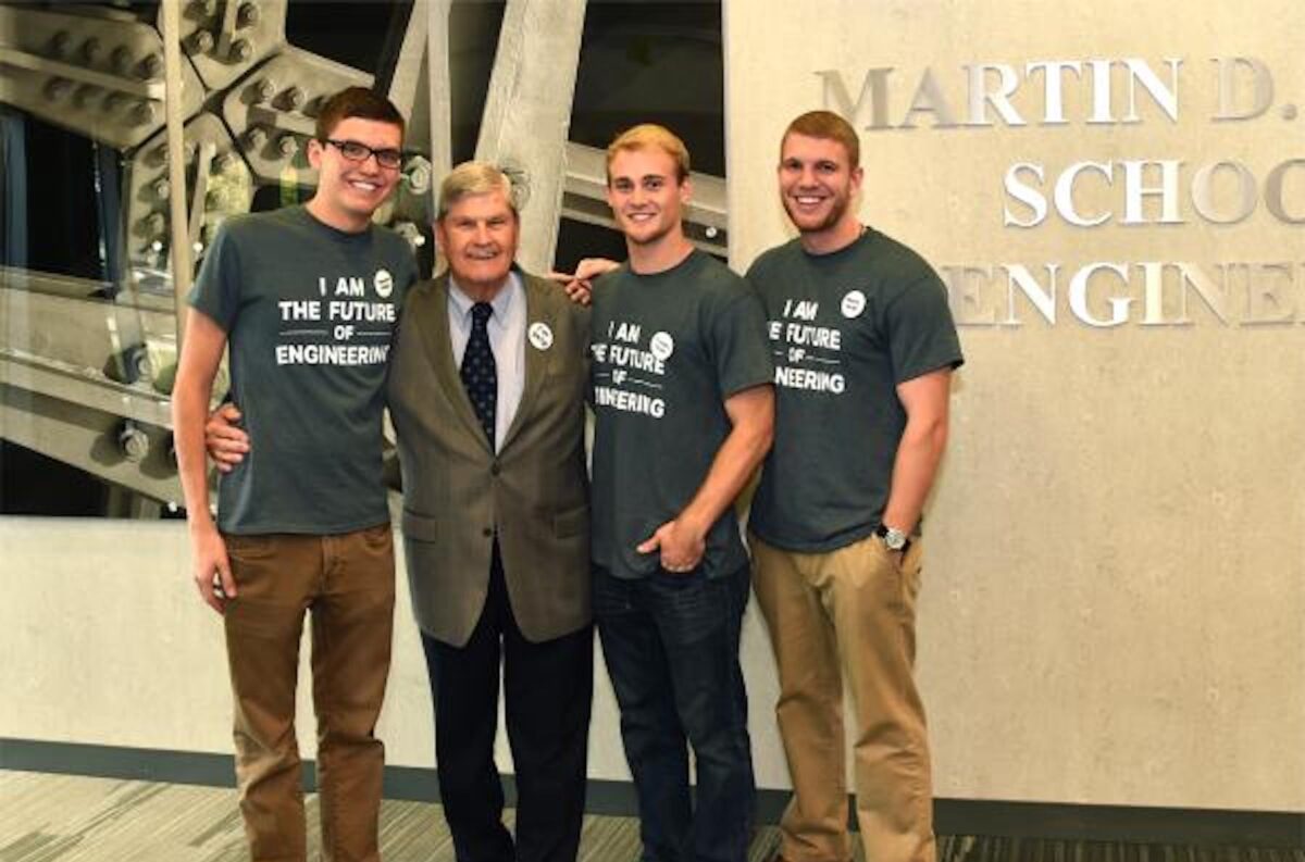 3 male students standing with Martin D. Walker