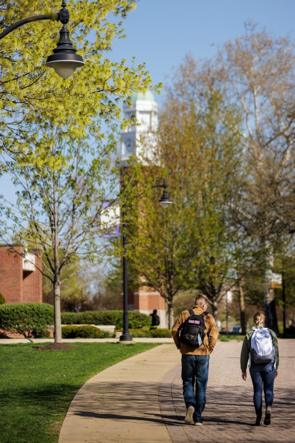 Two students walking towards the Melby clocktower