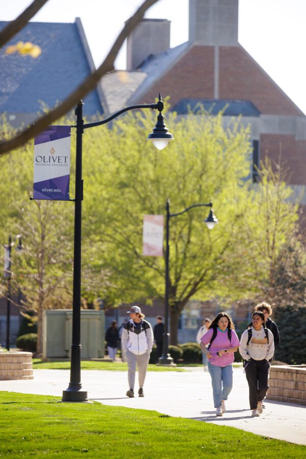 Three students walking through campus