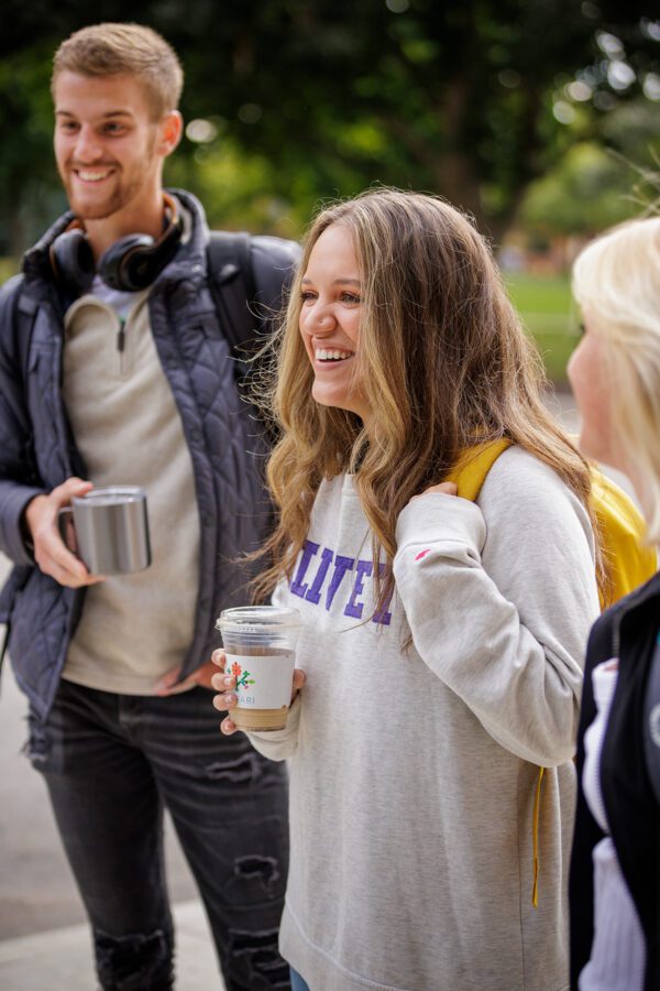 Two smiling students in the Quad