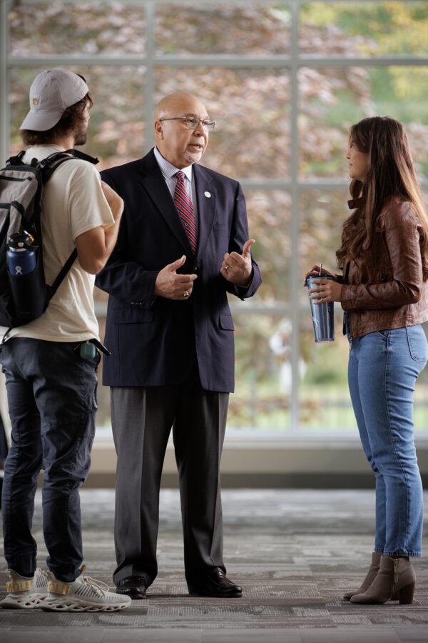 Professor engaging in conversation with students