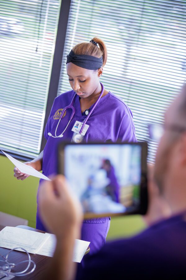 Nursing student examines a patient
