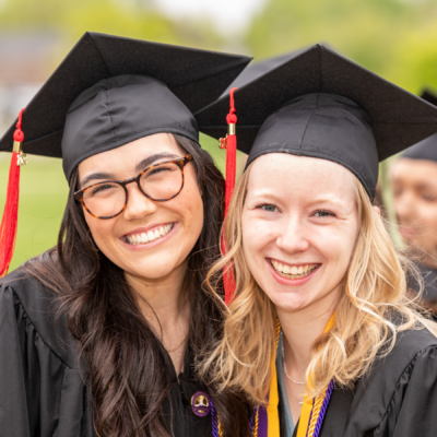 Photo of two smiling graduates
