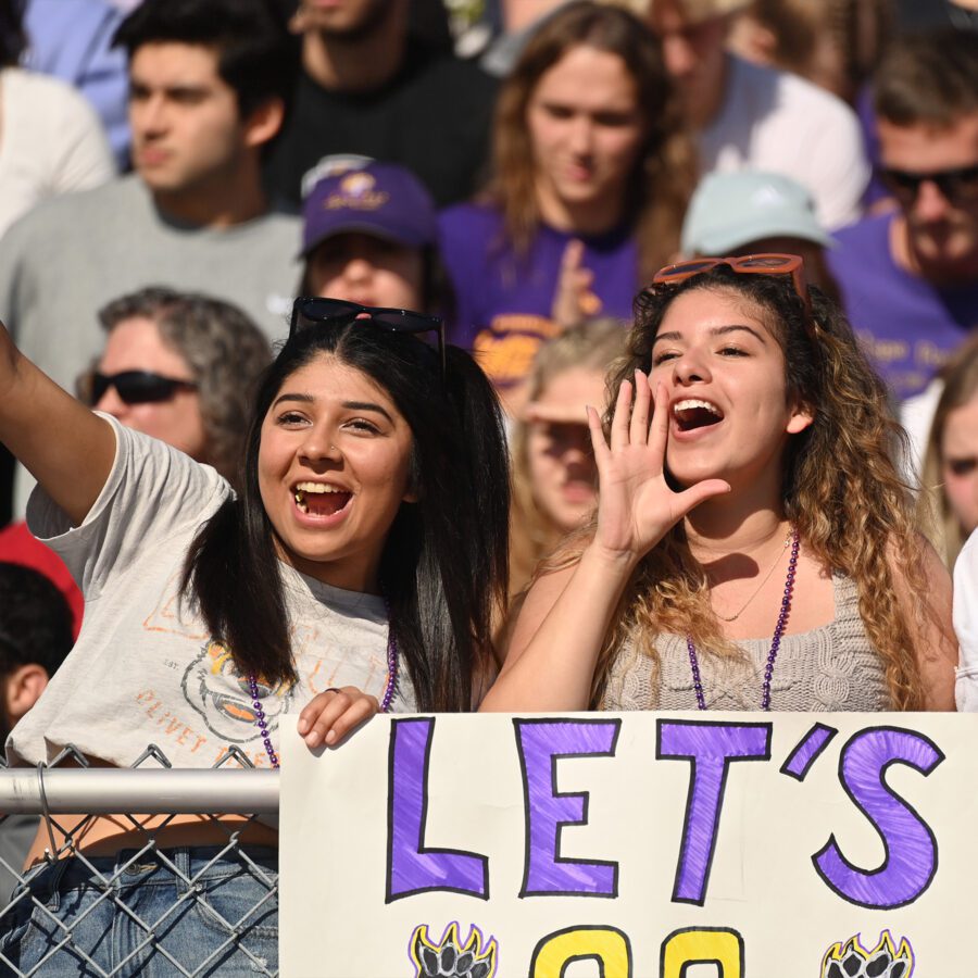 Cheering students at homecoming football game