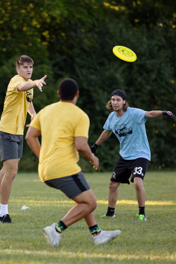 Group of male students playing frisbee