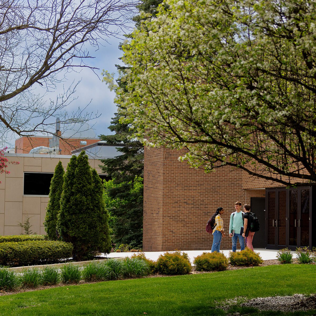 Group of three students outside of Larsen Fine Arts Center