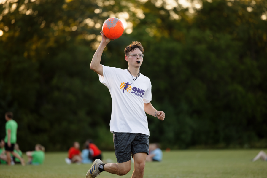 Intramural referee holding up soccer ball.