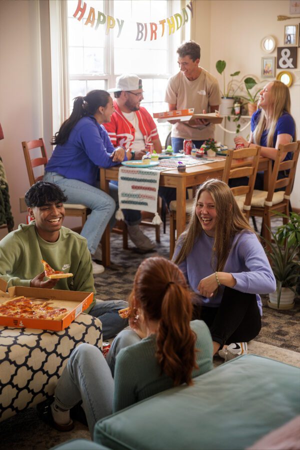 Group of friends having a pizza party in their apartment