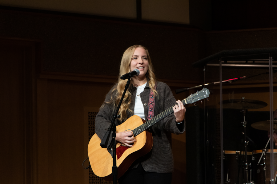 Smiling female guitarist in Centennial Chapel